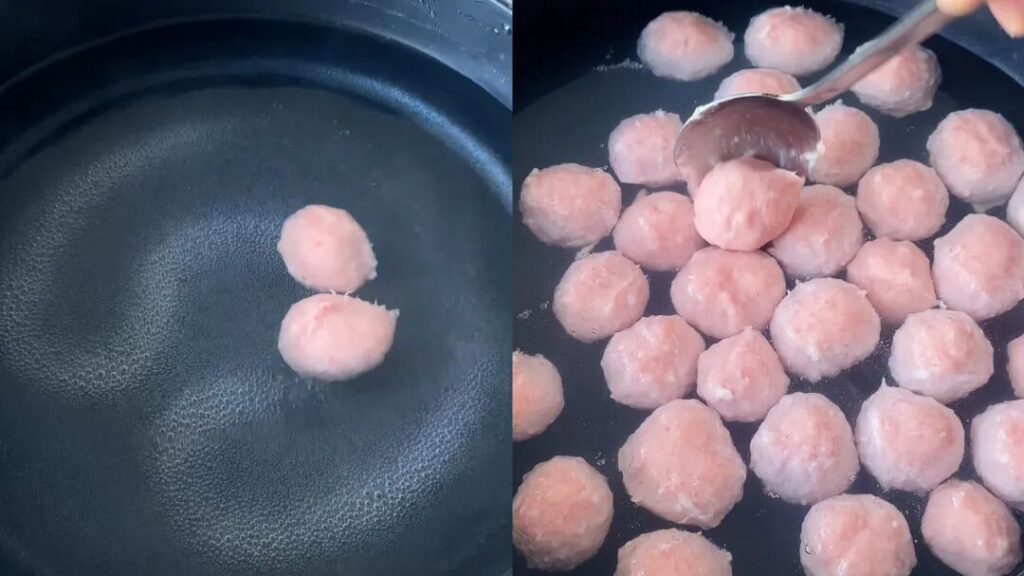 Simmering pork meatballs in warm water over low heat